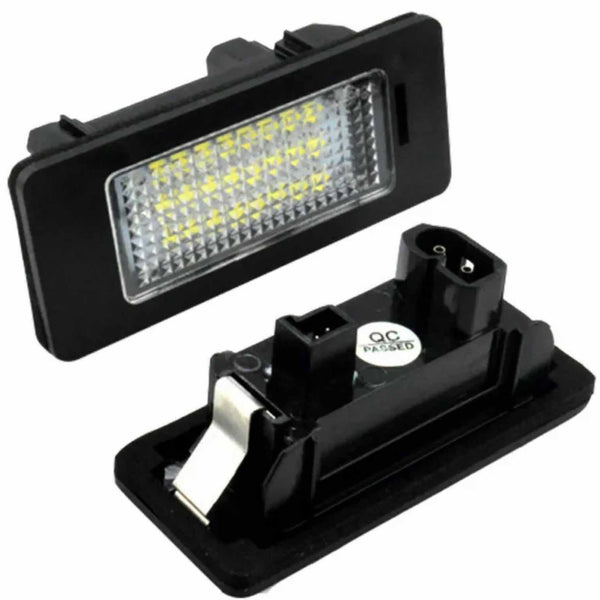 Rectangular LED light fixture with a grid of yellow diodes is connected to a black plastic housing. A "QC PASSED" sticker is visible on the back component.