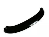 A shiny black car spoiler curves upward, designed to improve aerodynamics, set against a plain white background.