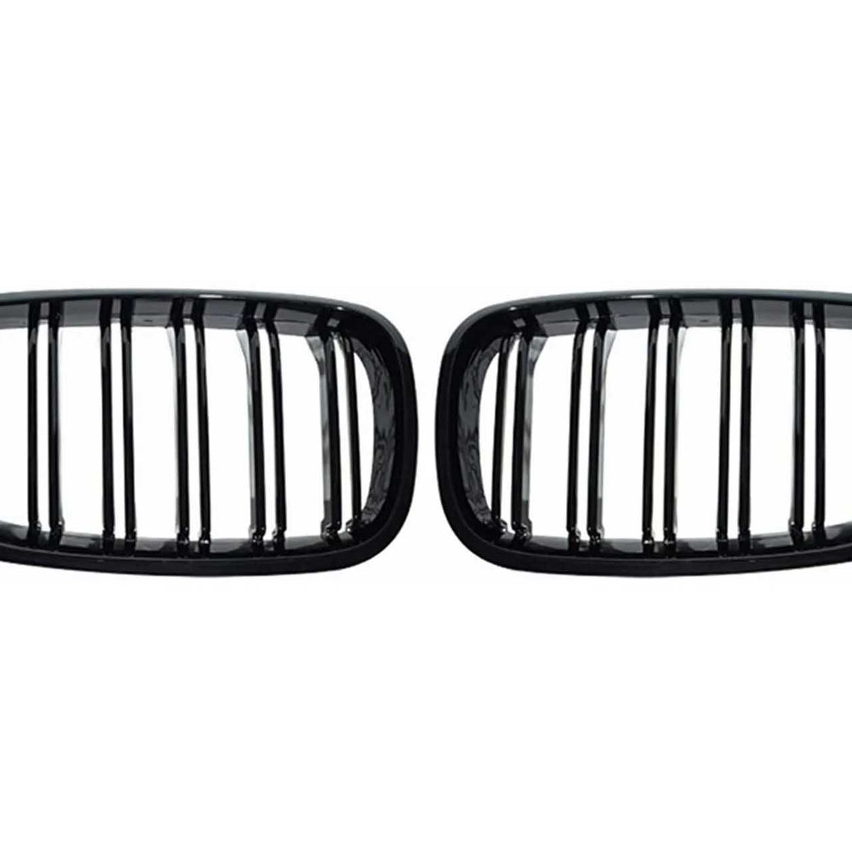 Two black, rectangular car grilles with vertical slats are symmetrically positioned on a plain white background, showcasing a sleek design.