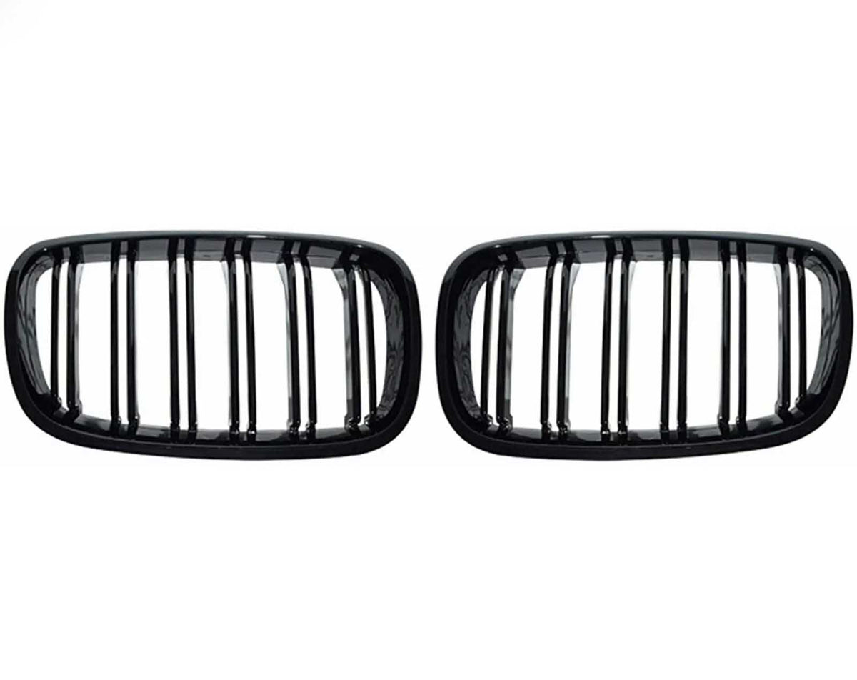 Two black, rectangular car grilles with vertical slats are symmetrically positioned on a plain white background, showcasing a sleek design.
