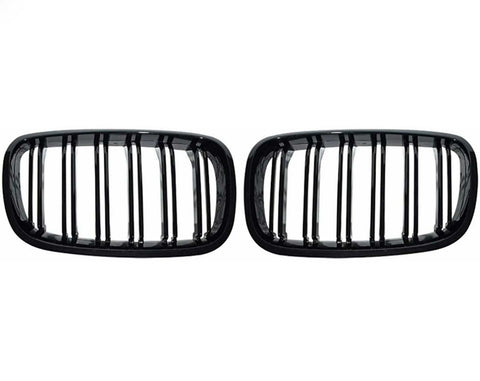 Two black, rectangular car grilles with vertical slats are symmetrically positioned on a plain white background, showcasing a sleek design.