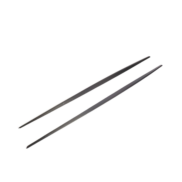 Two black metal chopsticks are parallel, resting on a plain white background, showcasing their sleek, slender design.
