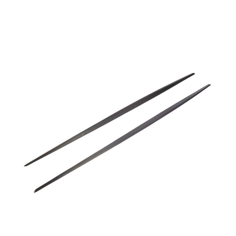 Two black metal chopsticks are parallel, resting on a plain white background, showcasing their sleek, slender design.