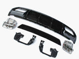 Car bumper components lie on a plain white surface, including black plastic and metallic parts arranged separately, showcasing a disassembled view typical for repairs or upgrades.