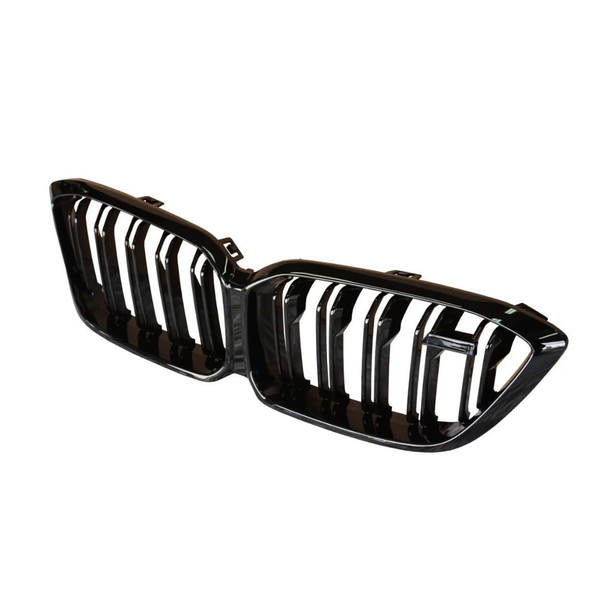 A shiny black car grille with vertical slats is centered against a plain white background. The grille has two symmetrical sections, resembling a dual-kidney shape.