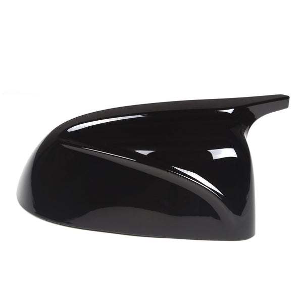 A glossy black car side mirror cover sits against a white background, showcasing its sleek, aerodynamic design with smooth curves and a sharp edge extending backward.
