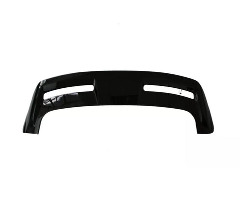 Curved black vehicle bumper with two elongated openings, shown against a plain white background.