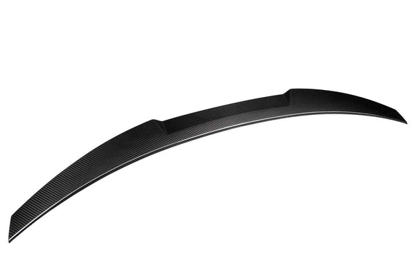 A curved carbon fiber car spoiler is shown on a white background, emphasizing its aerodynamic design and smooth texture.