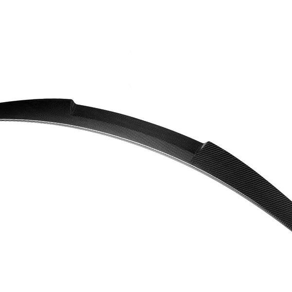 A curved, sleek black spoiler made of carbon fiber is presented against a plain white background, highlighting its aerodynamic design and glossy texture.