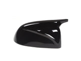 A glossy black car side mirror cover with a sleek, aerodynamic shape, displayed against a plain white background.
