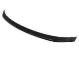 A black car spoiler curves gracefully, designed for aerodynamic effect, isolated against a plain white background.