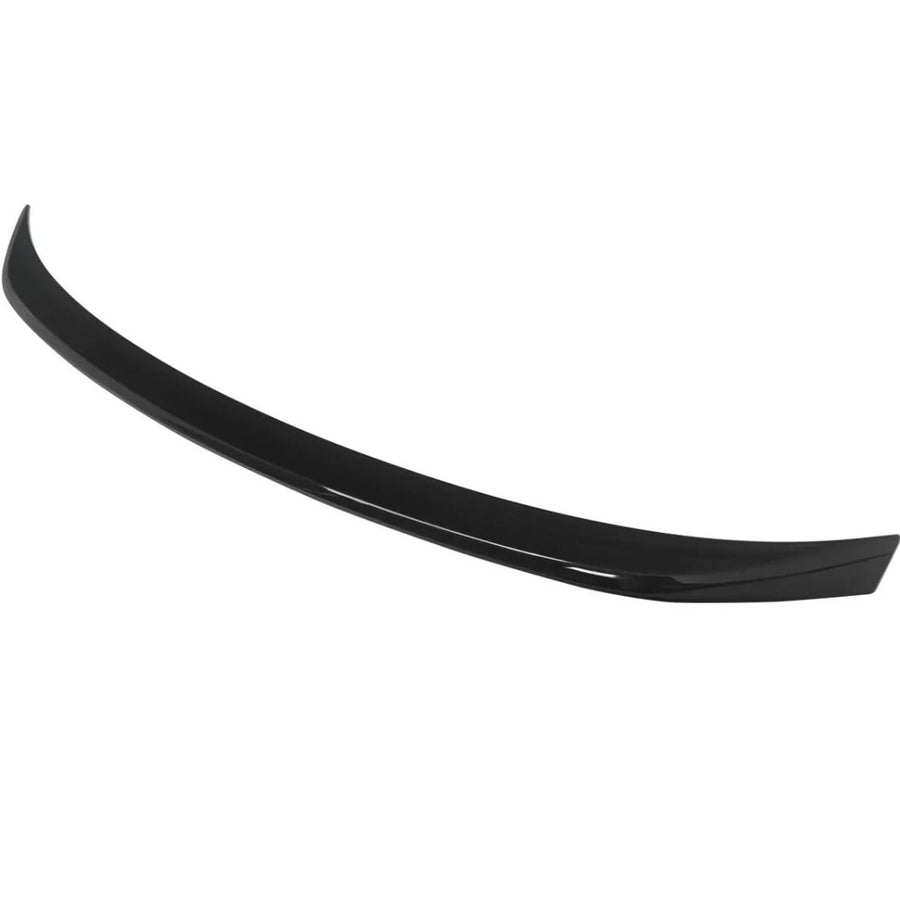 A black car spoiler curves gracefully, designed for aerodynamic effect, isolated against a plain white background.