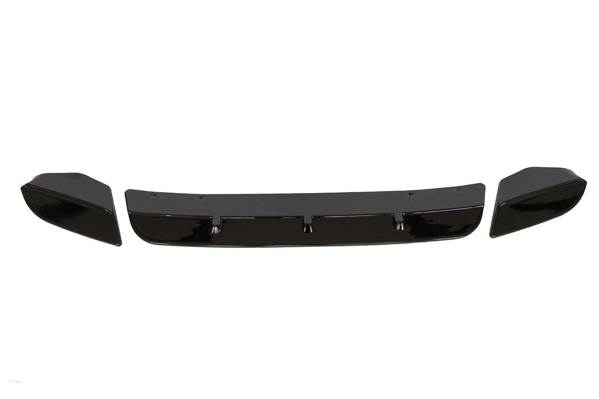 Three black car bumper parts, including a central spoiler and two end pieces, are aligned horizontally on a white background, suggesting an automotive component layout.