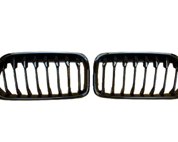 Two black car grilles with vertical slats are displayed side by side against a plain white background.