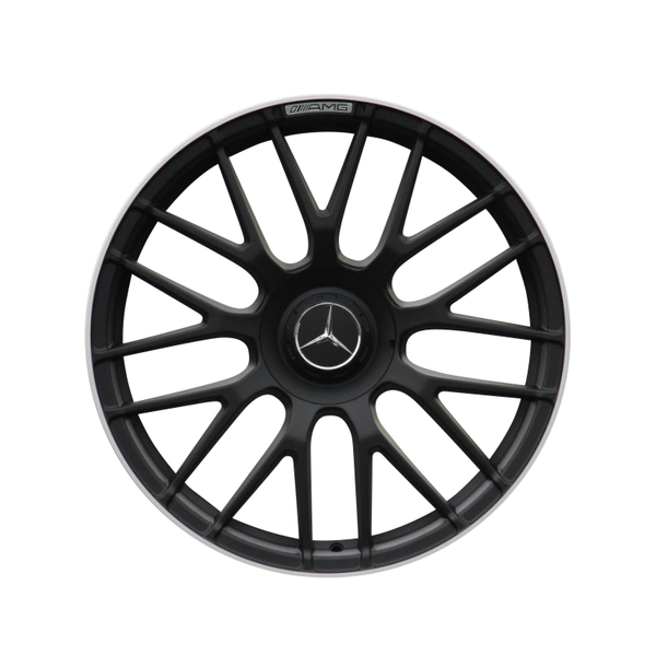 A black, multi-spoke car wheel rim with a central emblem and "AMG" text at the top, against a plain white background.