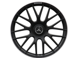 A black multi-spoke car wheel rim features a central Mercedes-Benz logo with the text 