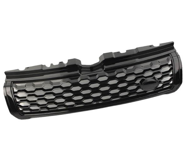 A black car grille features a honeycomb pattern, with a smooth emblem section. It rests in isolation against a plain white background.