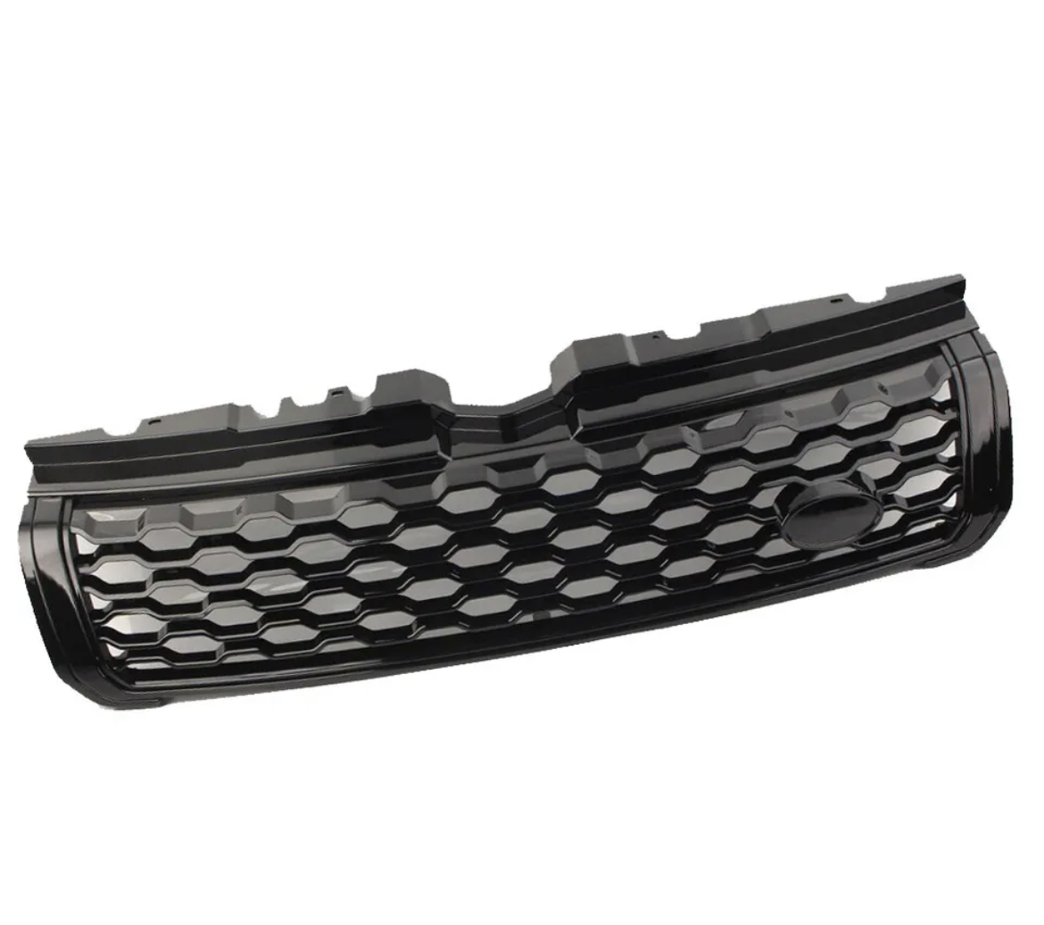 A black car grille features a honeycomb pattern, with a smooth emblem section. It rests in isolation against a plain white background.