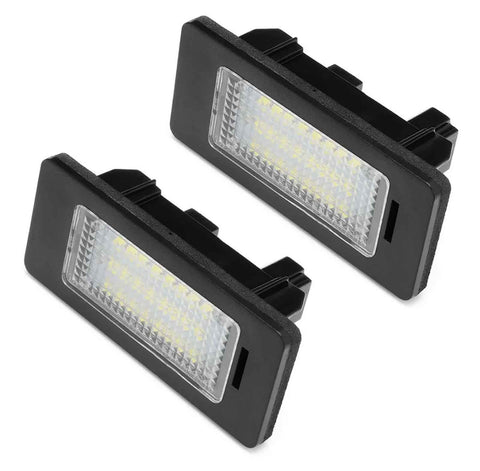 Two rectangular LED license plate lights positioned against a plain white background, featuring black frames and clear lenses revealing multiple small LED bulbs inside.