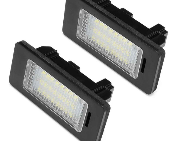 Two rectangular LED car lights, encased in black frames, are positioned at an angle, displaying a grid of yellow diodes. The background is plain white.