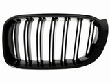 A black, rectangular car grille features multiple vertical slats. It is isolated against a white background, showcasing its glossy finish and curved edges.