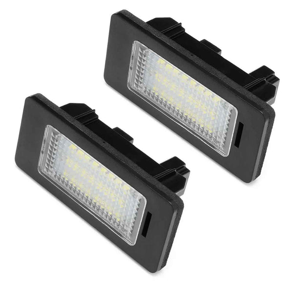 Two rectangular LED lights are placed side by side, featuring black casings and transparent panels with visible bulbs, against a plain white background.