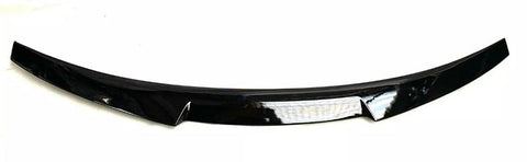 A black car spoiler with a glossy finish is positioned horizontally on a plain white background. The design is sleek, slightly curved, and features a central reflective strip.