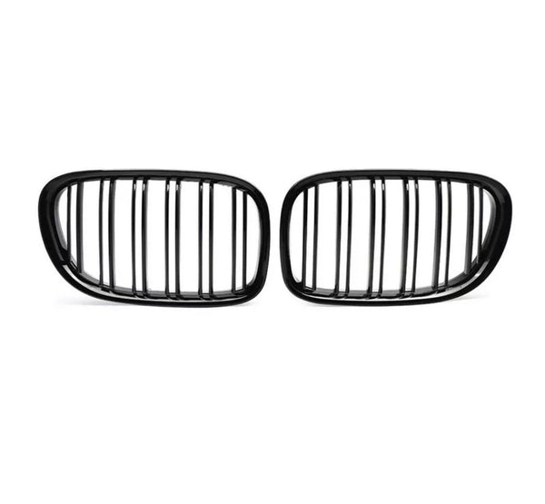 Two black, oval car grilles with vertical slats stand side by side against a white background, highlighting their sleek, symmetrical design.