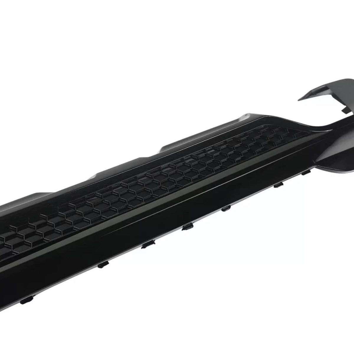 A black car bumper features a hexagonal pattern, curving upward slightly at one end. It's isolated on a plain white background.