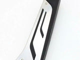 A metallic utility scraper with a black ergonomic grip rests on a white surface. Its sleek design features two screws near the edge, providing a secure hold.