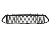 A black car grille with a honeycomb pattern lies flat, surrounded by a plain white background. It features mounting clips along the top edge.