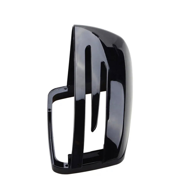 A glossy black car mirror cover with vertical slots, standing upright. The sleek, aerodynamic design suggests it is part of a modern vehicle's side mirror.