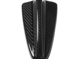 A sleek carbon fiber bike fender with a glossy surface, featuring a central ridge, rests against a plain white background, emphasizing its aerodynamic shape.