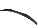 Curved carbon fiber car spoiler, sleek and aerodynamic, set against a plain white background.