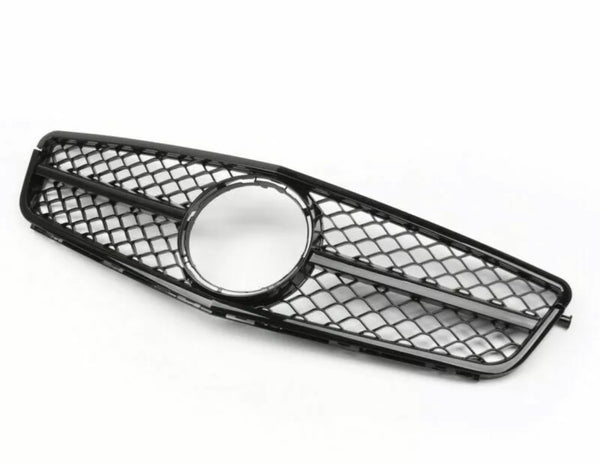A black car grille with a diamond-patterned mesh and a circular center frame lies on a plain white background.