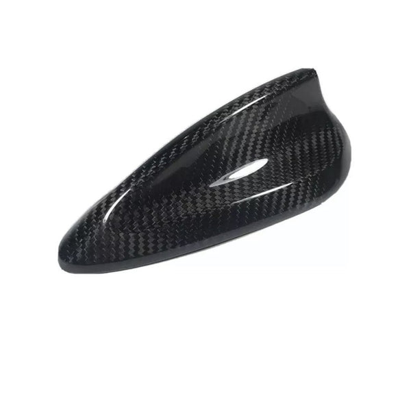 A sleek, black carbon fiber car side mirror cover, reflecting light, set against a plain white background.