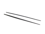 Two black chopsticks lie parallel, slightly spaced apart, on a white background. The chopsticks appear smooth and uniformly tapered towards the ends, set in a simple, minimal context.
