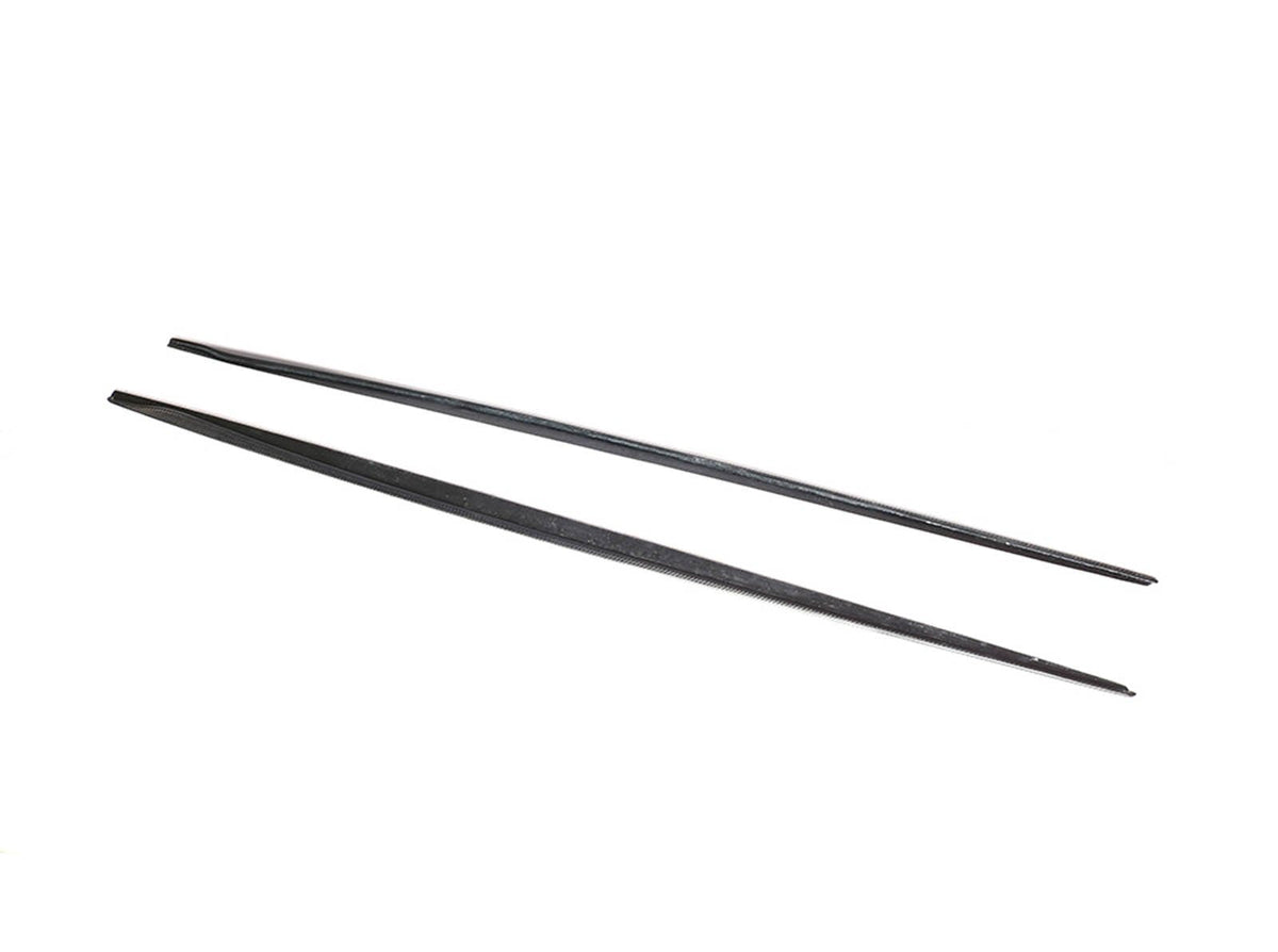Two black chopsticks lie parallel, slightly spaced apart, on a white background. The chopsticks appear smooth and uniformly tapered towards the ends, set in a simple, minimal context.