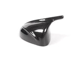 A glossy, black carbon fiber vehicle mirror cover is placed on a plain white background, showcasing its sleek, aerodynamic design and lightweight material.