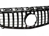 Black car grille with a rectangular grid pattern and a circular emblem space in the center, situated against a plain white background.