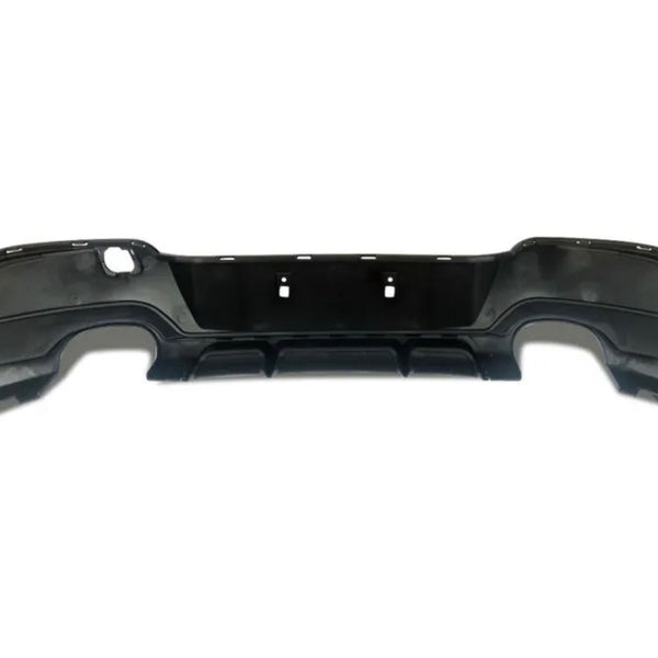 Black car bumper with cutouts for exhaust and mounting. The bumper is designed for rear attachment, featuring smooth contours and a flat backdrop, isolated on a plain white surface.