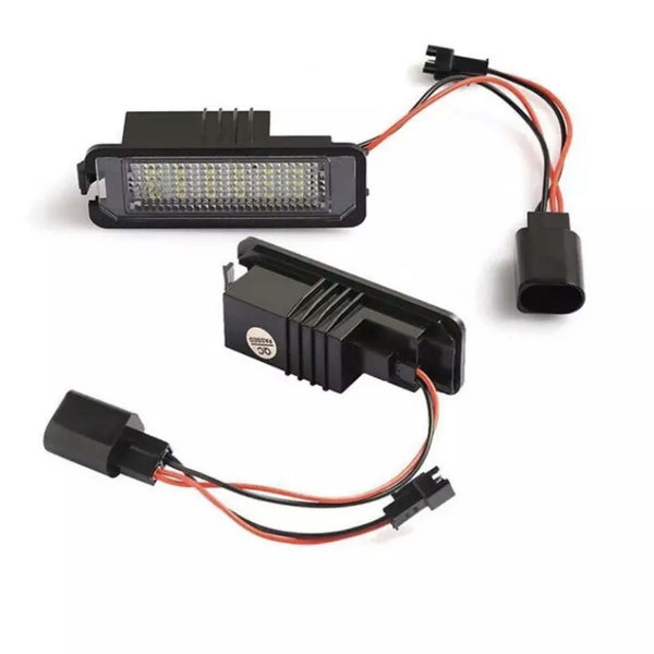 LED car lights featuring multiple small bulbs are connected by red and black wires to plastic plugs, set against a white background.