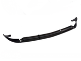 A black front lip spoiler, designed for automotive use, is displayed on a plain white background. It features aerodynamic contours with upward-curved edges, suggesting it is for enhancing vehicle aerodynamics.