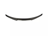 Curved, black carbon fiber car spoiler with a sleek design, resting against a plain white background.