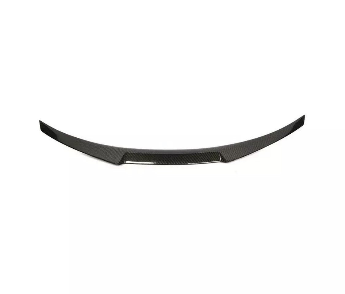 Curved, black carbon fiber car spoiler with a sleek design, resting against a plain white background.