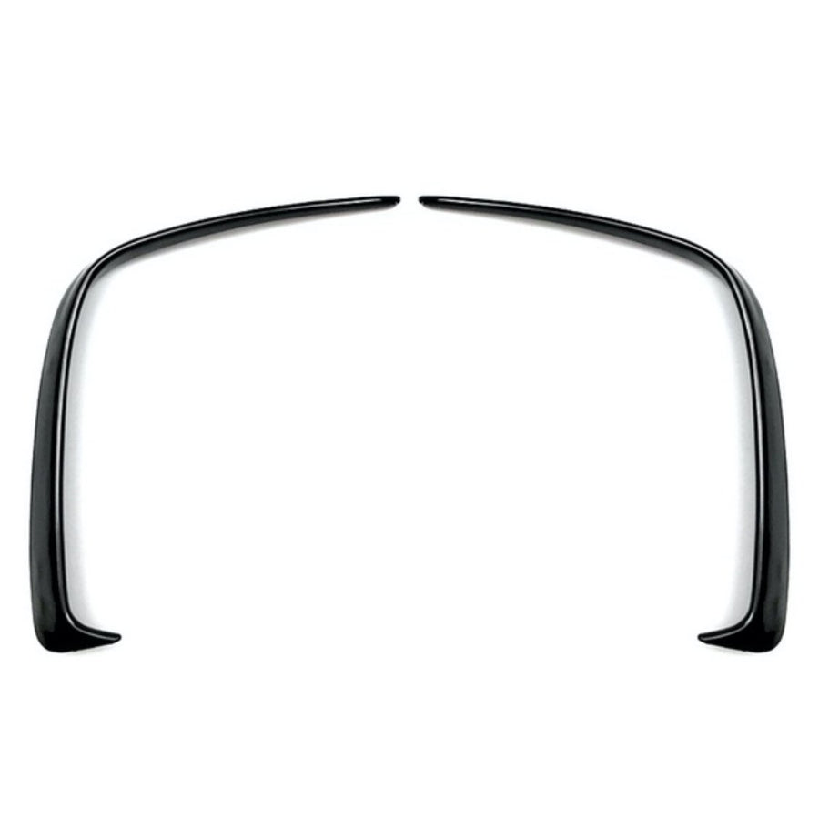 Two curved black plastic fender flares symmetrically facing each other, positioned on a plain white background.