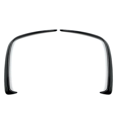 Two curved black plastic fender flares symmetrically facing each other, positioned on a plain white background.