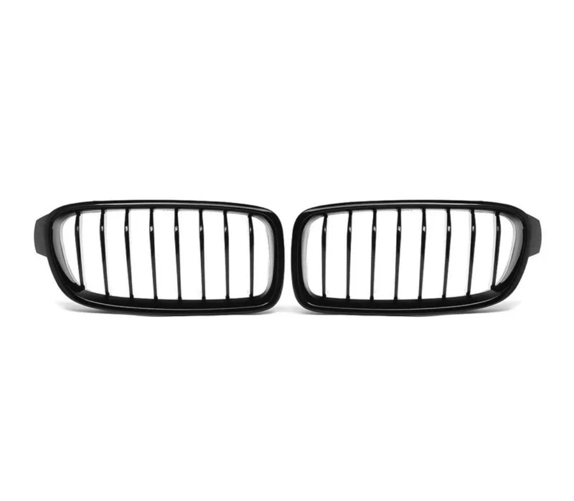 A pair of black, vertical-bar car grilles is placed on a plain white background, positioned side by side.