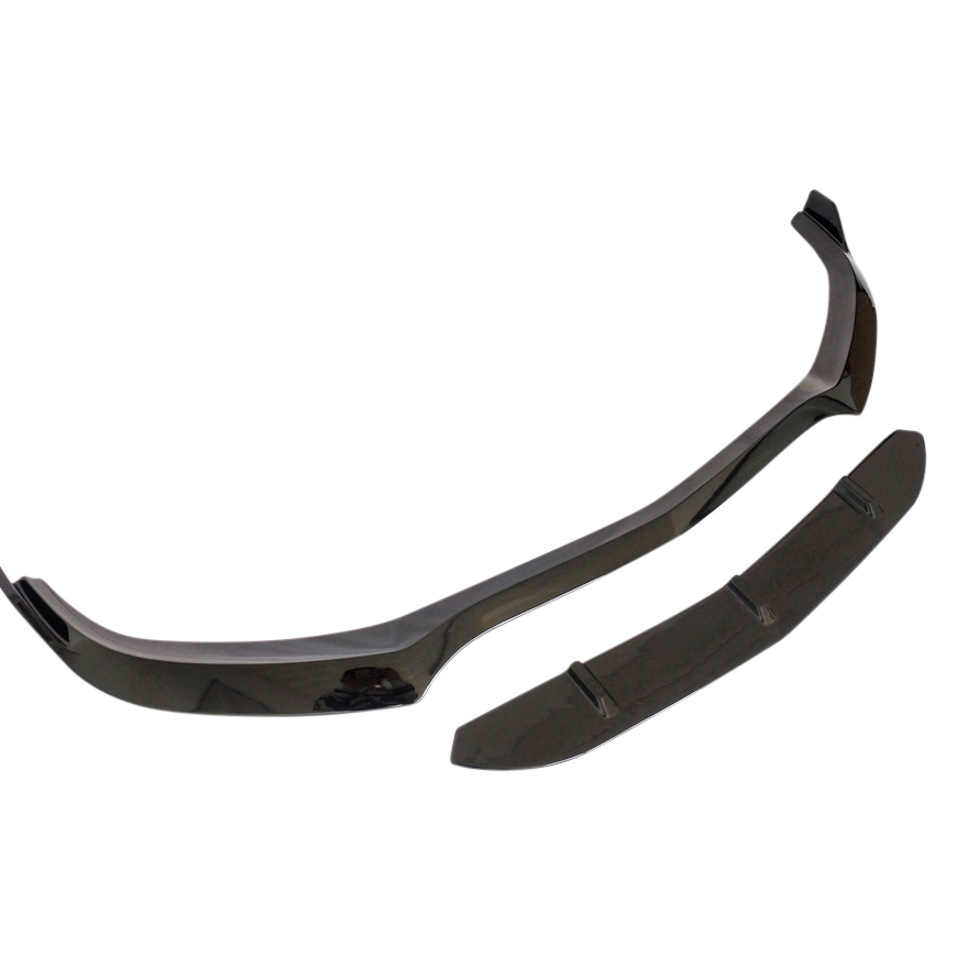 A black car front splitter lies against a white background, consisting of two separate aerodynamic pieces designed to improve vehicle stability and reduce drag.