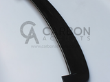 A black carbon fiber car spoiler rests on a white background. Text reads: 